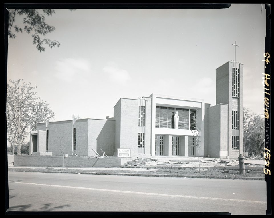 Black and white archival photograph of the same church and bell tower in 1957, the year it was built
